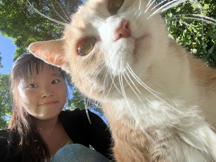 Aricia taking a selfie with a cat